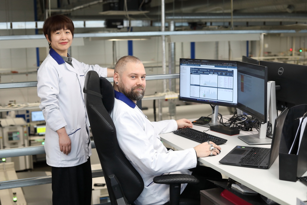 Woman and man working with computer in Scanfil factory