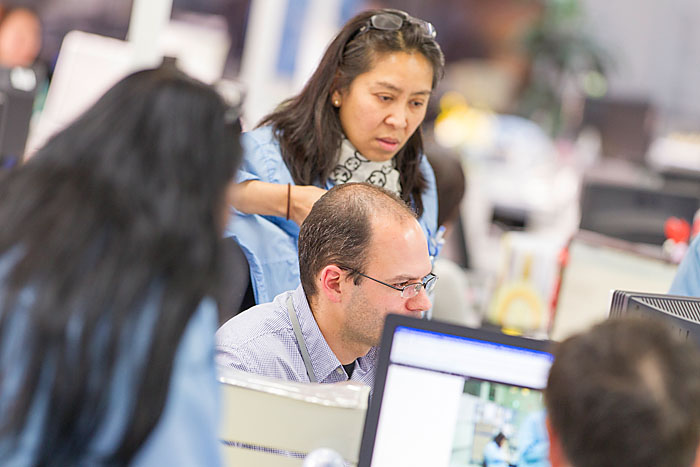 People working on computer in Scanfil factory